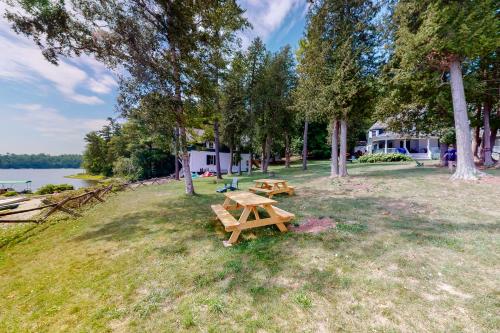 a picnic table in a field next to a lake at Garden Island's Maple in Charlotte