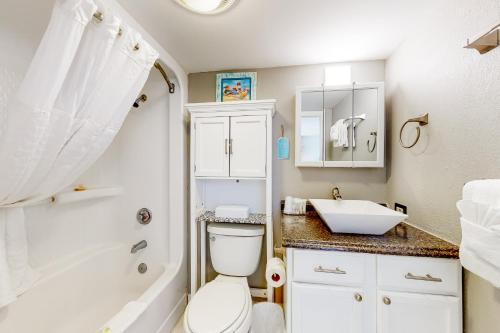 a bathroom with a toilet and a sink and a tub at Bay Watch 1901 in Myrtle Beach