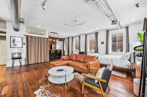 a living room with a couch and a table at Loft in the heart of Over-The-Rhine in Cincinnati