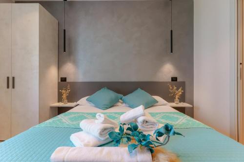 a bedroom with a bed with towels on it at Welcome Cagliari in Cagliari
