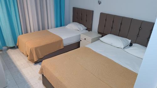 two beds in a hotel room with two bedsskirts at Tekirova butik hotel in Kemer