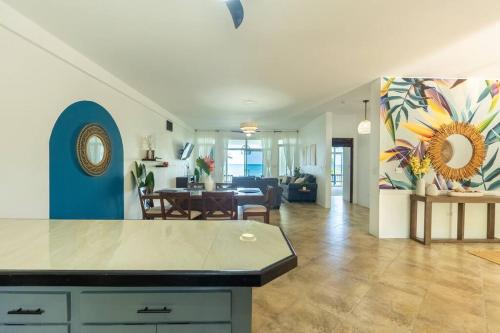 a living room with a kitchen and a dining room at Ivy's Cove Beach Side Condo - Luxury Villa in Whitehouse