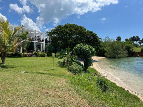 a house on the shore of a beach near the water at Ivy's Cove Beach Side Condo - Luxury Villa in Whitehouse