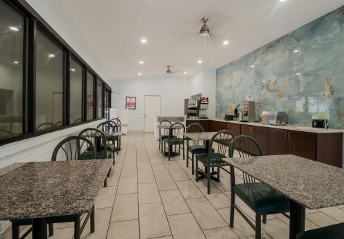 a restaurant with tables and chairs and a counter at Econo Lodge Inn & Suites Fulton - Rockport in Rockport