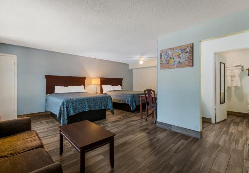 a hotel room with two beds and a couch at Econo Lodge Inn & Suites Fulton - Rockport in Rockport
