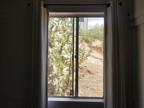 a window with a view of a desert view at 3BR Panoramic Lake View, Sequoia Forest, Kern County in Wofford Heights