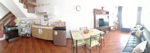 a kitchen and a living room with a table and chairs at SAN PAOLY. in Trujillo
