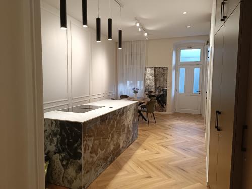 a kitchen with white cabinets and a counter top at MATE in Rijeka