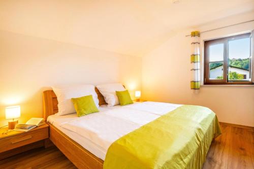 a bedroom with a large bed and a window at Ferienwohnung Am Moosbach in Übersee