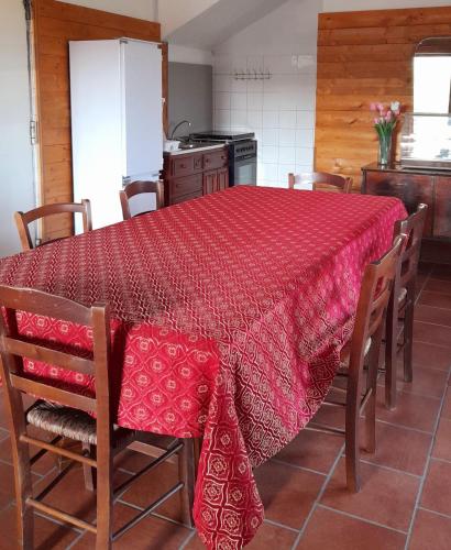 a kitchen with a table with a red table cloth at Villa Rosa B&B in Sellia Marina