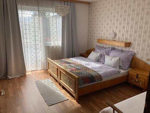 ein Schlafzimmer mit einem Bett und einem großen Fenster in der Unterkunft Moserwirt Pension in Sankt Veit an der Glan