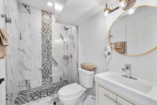 a bathroom with a toilet and a shower and a sink at Brand New on the Streetcar line in Cincinnati