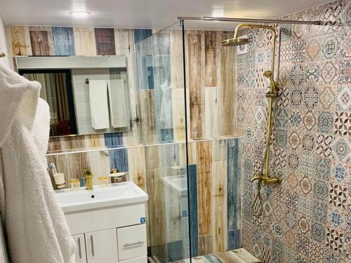 a bathroom with a shower and a sink at Luxury Aspar Apartment in Yerevan