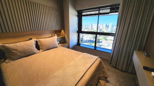 a hotel room with a bed and a window at Luxury Collection By Vertigo 23º Floor in Campo Grande