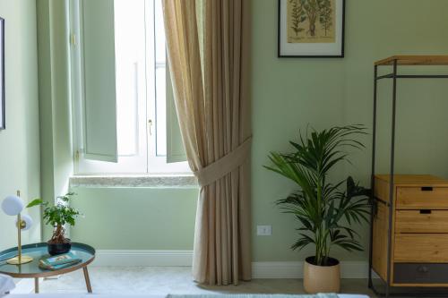 a living room with a window and a table at Palazzo Murat Luxury Rooms in Arienzo San Felice
