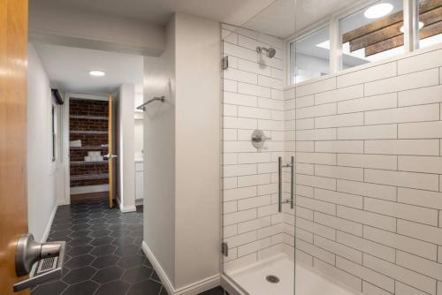 a bathroom with a shower with a glass door at Spacious Retreat w Private Roof Deck Walkable to ALL in Cincinnati
