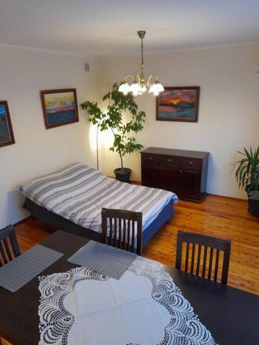 a bedroom with a bed and a table and chairs at Bronowice- parter domu in Kraków