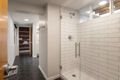 uma casa de banho com um chuveiro e uma porta de vidro em Stunning Loft in the heart of OTR em Cincinnati