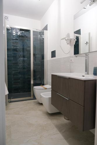a bathroom with a toilet and a tub and a sink at Palazzo Murat Luxury Rooms in Arienzo San Felice