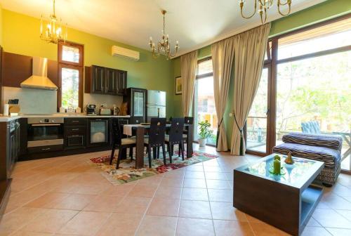 a large kitchen and living room with a table and chairs at Luxury 2 bedroom villa in Sozopolis in Sozopol