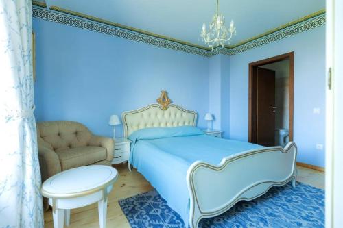 a blue bedroom with a bed and a chair at Luxury 2 bedroom villa in Sozopolis in Sozopol