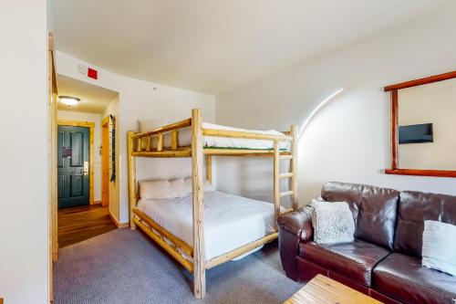 a living room with a bunk bed and a couch at Tucker Mountain Lodge 307 in Copper Mountain