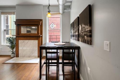 a dining room with a black table and chairs at City Escape 2BR Steps to TQL near OTR and Downtown in Cincinnati