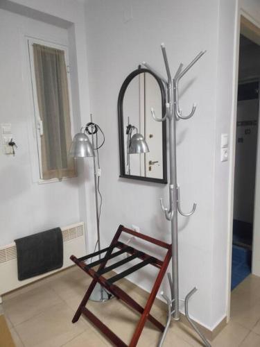 a bathroom with a towel rack and a mirror at Fanis & Polina -Mavrovouni beach in Mavrovoúnion