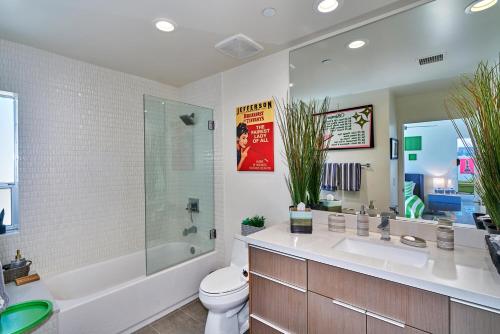 a bathroom with a sink and a toilet and a tub at Stunning Palm Springs 2 Bedroom Condo in Palm Springs
