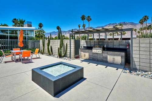 a patio with a grill and a table and chairs at Sophia Oasis Luxe 2BR Condo with Mountain Views in Palm Springs