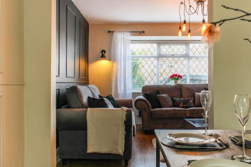 a living room with a couch and a table at Private driveway - close to Warwick Racecourse & Warwick Castle!! in Warwick