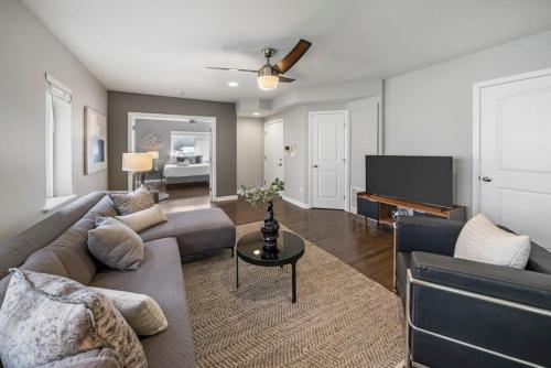 a living room with a couch and a tv at Comfortable 2BR Condo near City Center in Cincinnati