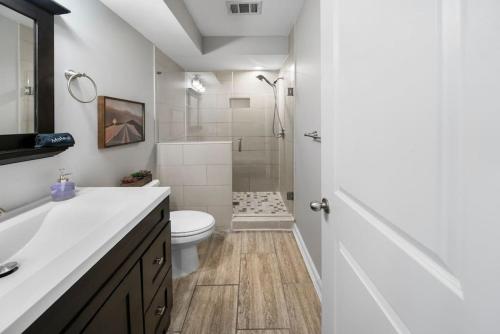a bathroom with a shower and a toilet and a sink at Comfortable 2BR Condo near City Center in Cincinnati