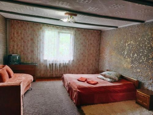 a bedroom with a bed with a dog laying on it at Подих Карпат in Slavske