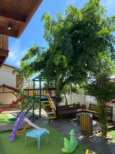 a play area with a playground with a slide at Pousada Rosália in Penha