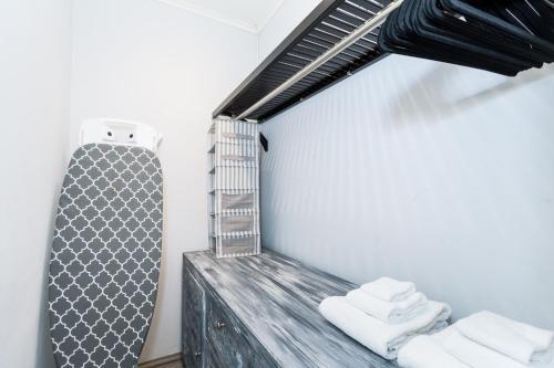 a room with white towels on a wooden shelf at Topaz 8 in Palm-Eagle Beach