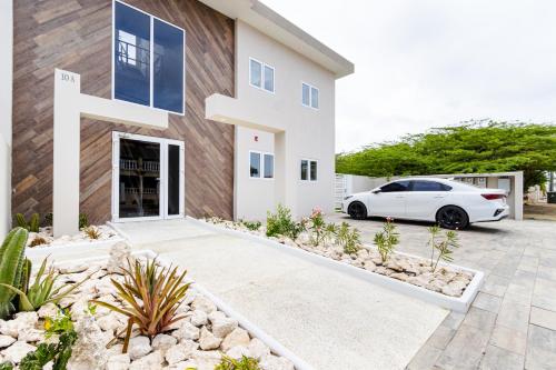a white car parked in front of a house at Summerside 4 Rooi Santo 10-A in Palm-Eagle Beach
