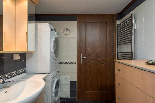 a kitchen with a washer and dryer and a sink at AnnaBoutique Villa Beach, Heated Private Pool & BBQ in Kato Daratso