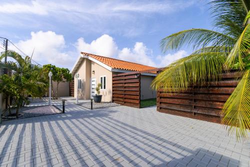 a house with a wooden fence and a patio at Solito 52 in Oranjestad