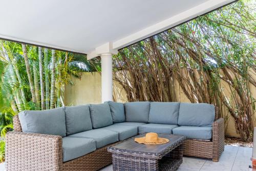 a blue couch sitting on a patio with a table at Koyari 36-F in Palm-Eagle Beach