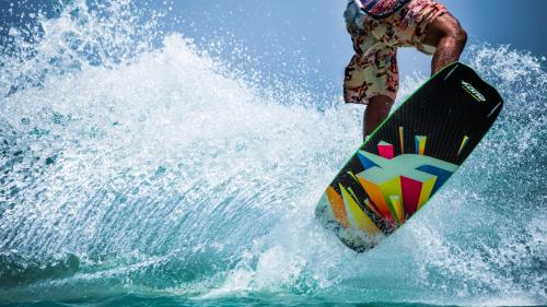 a man riding a wave on a surfboard in the ocean at Koyari 36-F in Palm-Eagle Beach