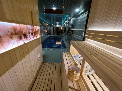 a sauna with a bench and a walk in shower at HOTEL DaMir in Samarkand