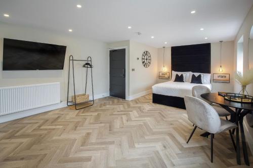 a bedroom with a bed and a desk and a table at Five Apartments in Blackpool