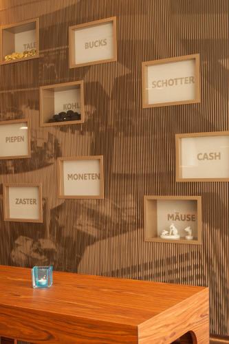 a room with a wall with signs on it at Motel One Frankfurt Messe in Frankfurt/Main