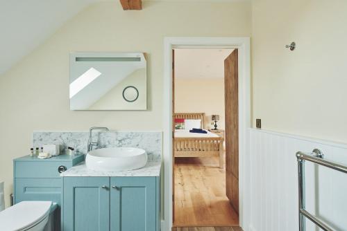 a bathroom with a blue cabinet and a sink at Big Barn 