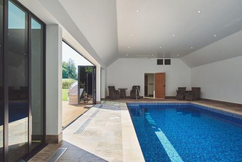 a swimming pool in the middle of a house at The Byre 