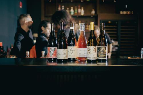 a group of bottles of wine sitting on a bar at The Cloud One New York-Downtown, by the Motel One Group in New York
