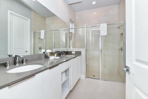 a bathroom with a sink and a shower at Magnificent Condo w/ Reunion Water Park Access near Disney by Spectrum Resort Orlando by Rentyl - B7 #128 in Kissimmee