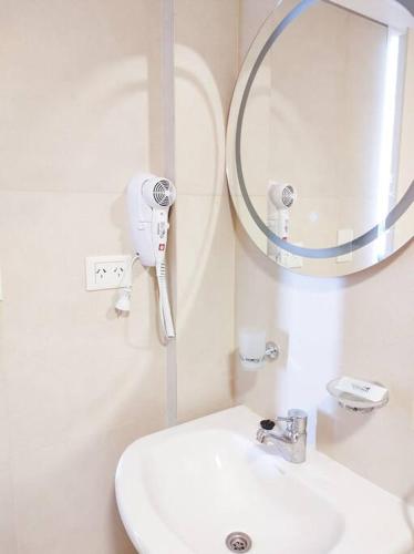 a white bathroom with a sink and a mirror at AZUL - Pto Madryn in Puerto Madryn