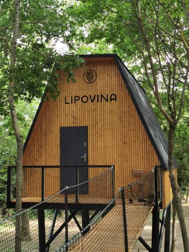 a large wooden building with the wordhovarma on it at TREE-TOP VILLAGE, Tokajské domčeky v korunách stromov in Malá Bara